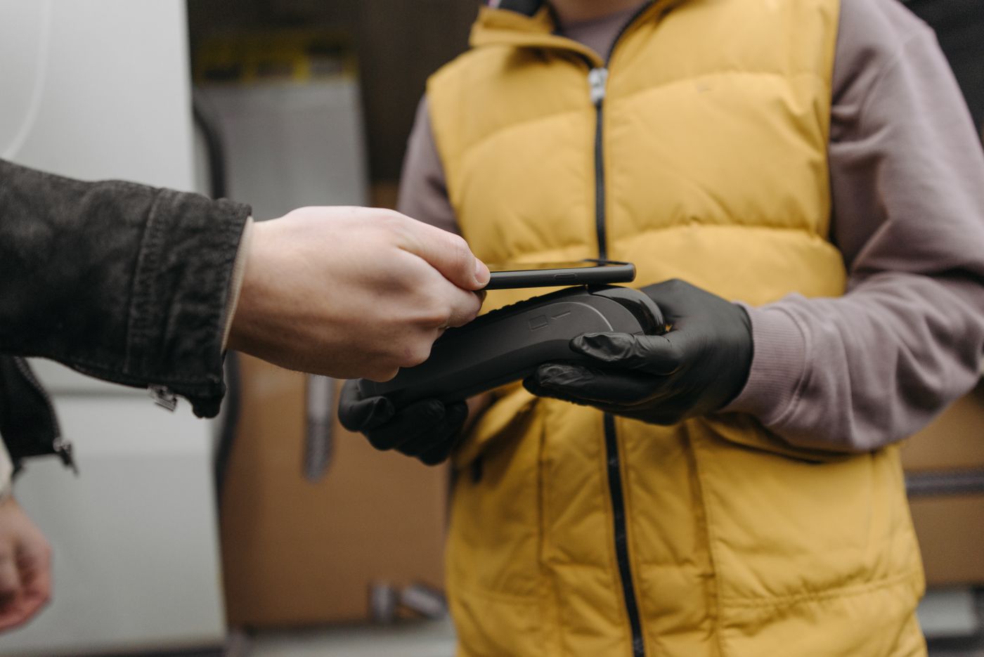 A customer paying by phone on a card terminal