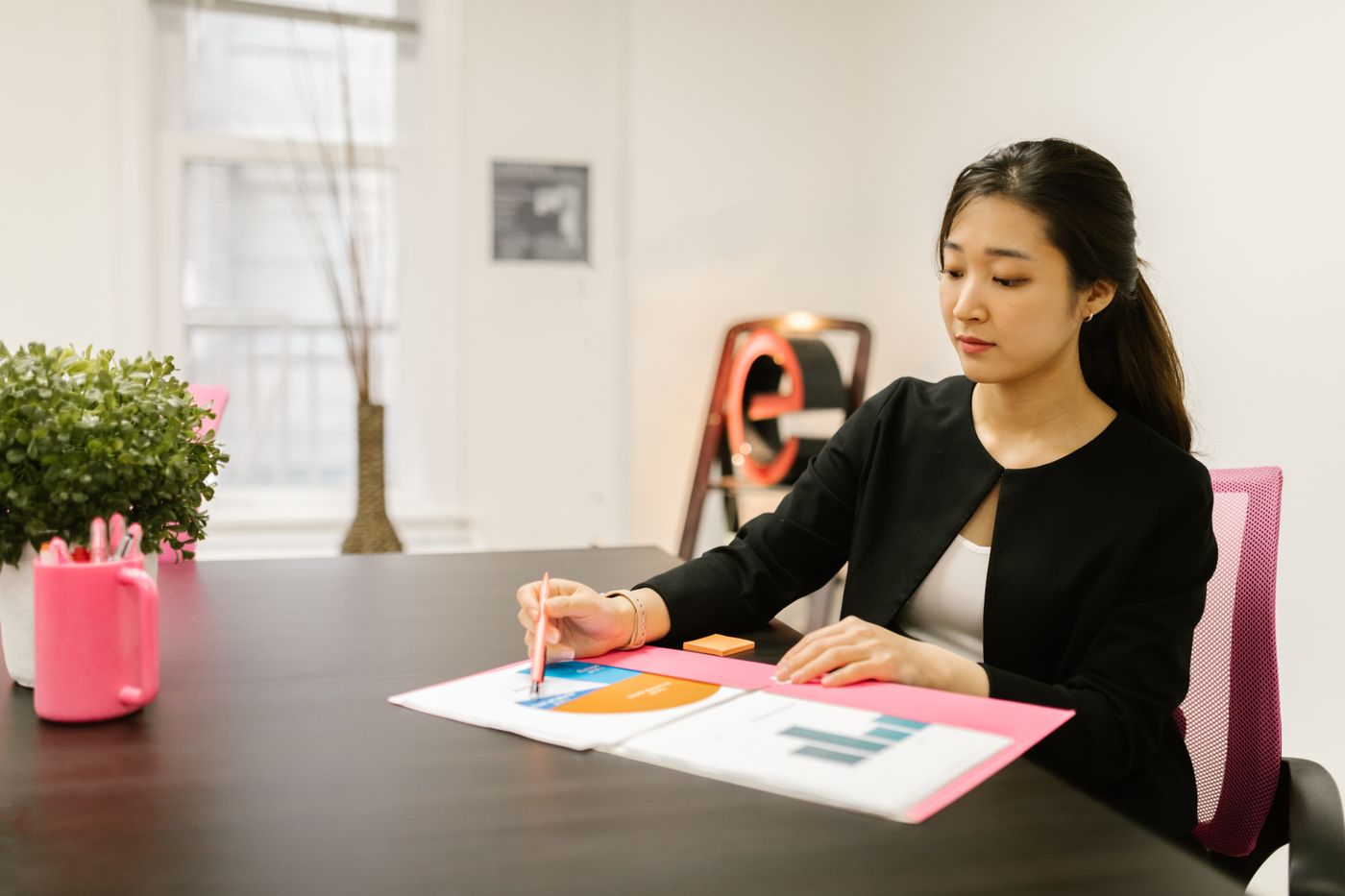 A finance officer reviewing charts at a desk