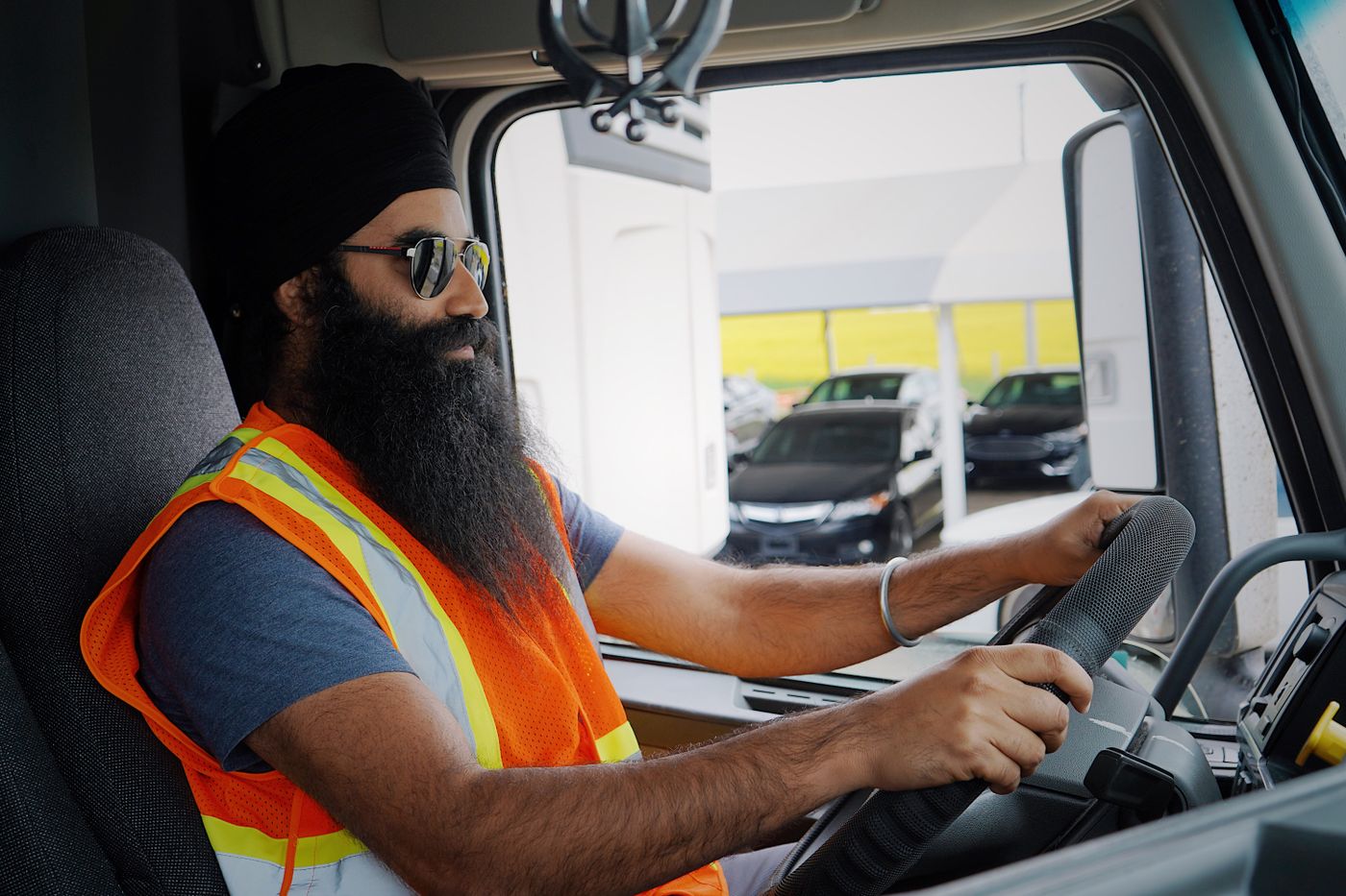 A lorry driver at the wheel in the cab