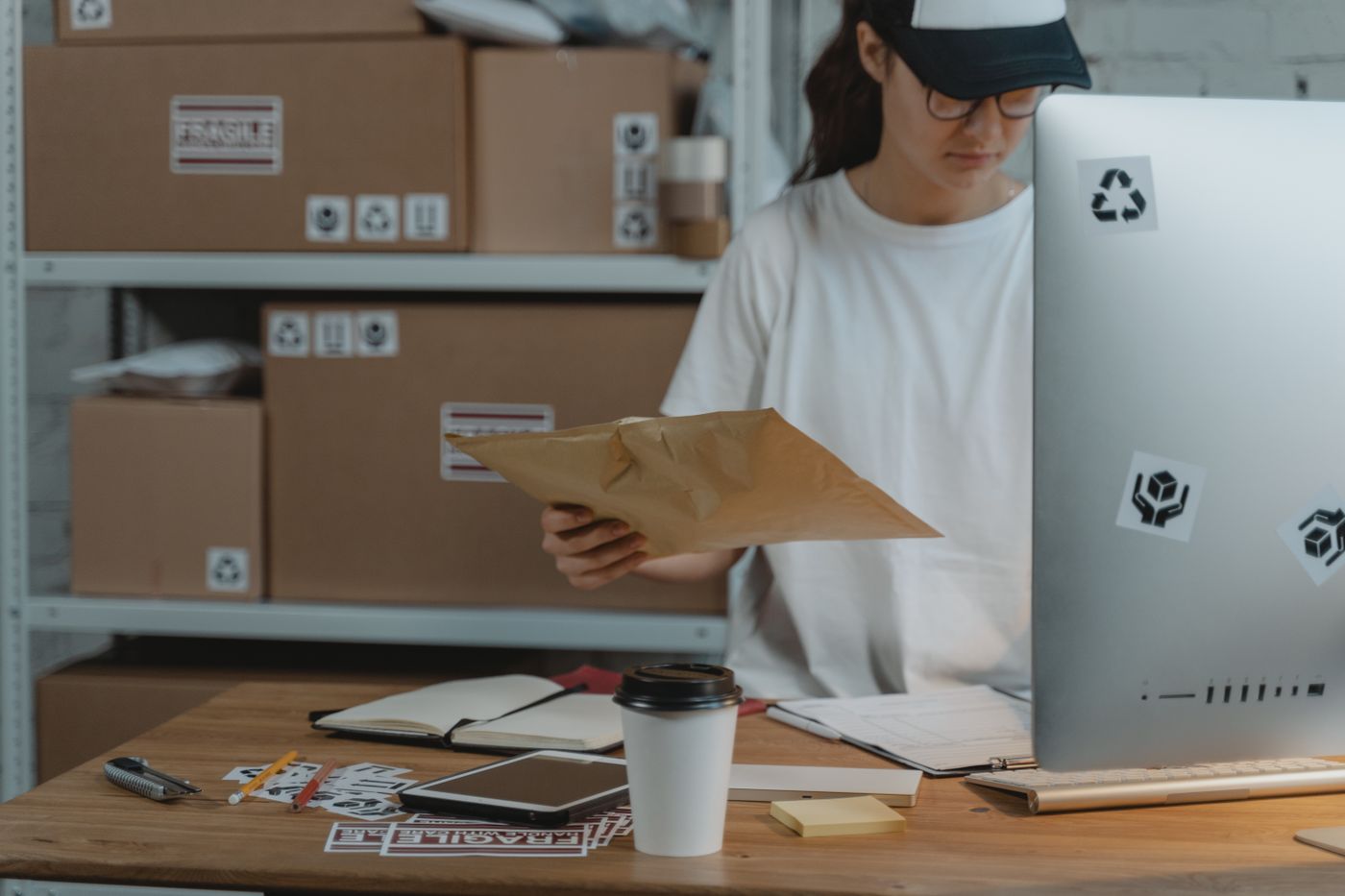 A warehouse worker checking a parcel at a computer